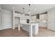 Well-lit kitchen featuring an island, pendant lights, white cabinets, and stainless steel appliances, perfect for cooking at 304 Balboa St, Matthews, NC 28104