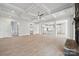 Bright open-concept living room with hardwood floors, fireplace, and coffered ceiling, seamlessly connecting to the kitchen at 304 Balboa St, Matthews, NC 28104
