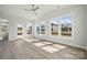 Inviting living room with ceiling fan, wood floors, and multiple windows offering lots of natural light at 304 Balboa St, Matthews, NC 28104