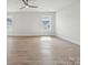 Bright living room featuring hardwood floors, large windows, and recessed lighting at 304 Balboa St, Matthews, NC 28104