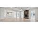 Open-concept living room with hardwood floors, coffered ceilings, and stone fireplace, seamlessly connecting to the kitchen at 304 Balboa St, Matthews, NC 28104