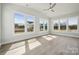 Sunlit living room features vaulted ceilings, ceiling fan, and multiple windows showcasing neighborhood views at 304 Balboa St, Matthews, NC 28104