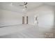 Bright main bedroom with vaulted ceiling, carpet, ceiling fan, and ensuite bathroom at 304 Balboa St, Matthews, NC 28104
