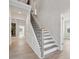 Bright foyer with a staircase featuring neutral decor and light hardwood floors, creating an inviting entry at 304 Balboa St, Matthews, NC 28104