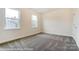 Bedroom with neutral walls, carpeted flooring, and natural light from two windows at 3056 Bent Willow Dr # 175, Indian Trail, NC 28079