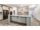 Modern kitchen with stainless steel appliances, island, and stone backsplash at 3056 Bent Willow Dr # 175, Indian Trail, NC 28079