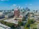 Aerial view showcases the Charlotte skyline, surrounding buildings, and lush green trees at 310 Arlington Ave # Multiple, Charlotte, NC 28203