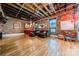 Spacious living room boasts exposed brick, wood floors, and exposed wood beam ceilings at 310 Arlington Ave # Multiple, Charlotte, NC 28203
