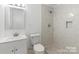 Bathroom with tile shower, a modern vanity, updated fixtures, and neutral finishes at 332 Mountain View St, Gastonia, NC 28052