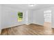 Bright bedroom featuring hardwood flooring, a bright window, and neutral paint at 332 Mountain View St, Gastonia, NC 28052
