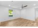 Bright bedroom with ceiling fan, wood-look floors, and neutral wall paint at 332 Mountain View St, Gastonia, NC 28052