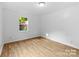 Well-lit bedroom featuring hardwood flooring, a bright window, and neutral paint at 332 Mountain View St, Gastonia, NC 28052