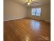 Bright bedroom featuring hardwood floors, a ceiling fan, and large window with natural light at 3367 Marshall Wolfe Rd, Kings Mountain, NC 28086