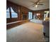 Spacious living room featuring a brick fireplace, wood paneling, and natural light at 3367 Marshall Wolfe Rd, Kings Mountain, NC 28086