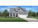 Charming new construction home featuring blue siding, a two-car garage, and a covered porch at 3468 Aleppo Ave # 366, Indian Land, SC 29707