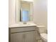 Bathroom featuring gray vanity with modern faucet and ample storage space at 3924 Craig Ave, Charlotte, NC 28211