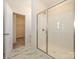 Bathroom featuring glass enclosed shower, marble tile, and walk-in closet at 3924 Craig Ave, Charlotte, NC 28211