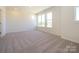 Bright bedroom with plush carpet, and abundant natural light from many windows at 3924 Craig Ave, Charlotte, NC 28211