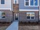A welcoming brick townhome entrance with a covered porch and clear address number displayed above the door at 3924 Craig Ave, Charlotte, NC 28211