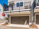 Townhome featuring a two car garage with balcony above and modern facade at 3924 Craig Ave, Charlotte, NC 28211