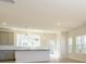 Contemporary kitchen featuring stainless steel appliances, white cabinets, and large windows at 3924 Craig Ave, Charlotte, NC 28211