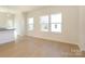 Sun-filled living room with hardwood floors, large windows, and neutral color scheme at 3924 Craig Ave, Charlotte, NC 28211