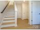 Inviting staircase showcasing wood stairs, a white banister, and natural light for a bright, modern feel at 3924 Craig Ave, Charlotte, NC 28211