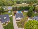 Aerial view showcasing the home, in-ground pool, backyard play area, storage building and surrounding neighborhood at 406 Llewellyn St, Belmont, NC 28012