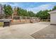 Expansive backyard with patio, deck, grilling area and mature trees perfect for outdoor entertaining at 406 Llewellyn St, Belmont, NC 28012