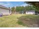 Spacious backyard with a well-maintained lawn, storage shed, and play area offers outdoor enjoyment at 406 Llewellyn St, Belmont, NC 28012