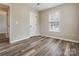 Comfortable bedroom featuring wood-look floors, a ceiling fan, and a bright window at 406 Llewellyn St, Belmont, NC 28012