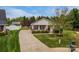 Charming home featuring a manicured front yard with lush green grass, driveway, and well-kept landscaping at 406 Llewellyn St, Belmont, NC 28012