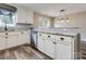 Kitchen with granite counters, stainless appliances and white cabinetry plus pendant lighting at 406 Llewellyn St, Belmont, NC 28012
