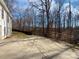 Large backyard with a patio, grassy area, and wooded area offering privacy at 414 Fox Fire Run, Gastonia, NC 28052