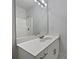 Bathroom vanity with white countertop, chrome faucet, and large mirror reflecting the shower at 414 Fox Fire Run, Gastonia, NC 28052