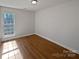 Sunny bedroom featuring beautiful hardwood floors and a large window offering ample natural light at 414 Fox Fire Run, Gastonia, NC 28052