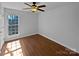 Bedroom featuring a ceiling fan, hardwood floors, and a bright window offering ample natural light at 414 Fox Fire Run, Gastonia, NC 28052