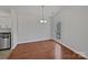 Bright dining room with hardwood floors, modern lighting, and a glass door leading to the outdoors at 414 Fox Fire Run, Gastonia, NC 28052