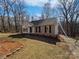 Charming one-story brick home featuring black shutters, manicured landscaping, and a private driveway at 414 Fox Fire Run, Gastonia, NC 28052