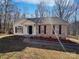 Charming single-story home with a brick facade, white siding and black shutters at 414 Fox Fire Run, Gastonia, NC 28052