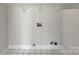 Laundry room featuring tile flooring, utility hookups, and wire shelving for easy storage at 414 Fox Fire Run, Gastonia, NC 28052
