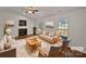 Bright living room with a fireplace, hardwood floors, plush rug, and natural light at 414 Fox Fire Run, Gastonia, NC 28052