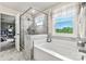 Bright bathroom with a glass-enclosed shower and separate tub at 419 Balboa St, Matthews, NC 28104