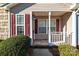 Inviting front porch with storm door and beautiful burgundy shutters at 450 Guiness Pl, Rock Hill, SC 29730