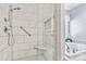 This bright bathroom has a newly tiled shower and an adjacent soaker tub with marbled surround at 4522 Long Cove Dr, Denver, NC 28037
