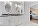 Bathroom has a double sink vanity with marble countertop and a view into the main bedroom at 4522 Long Cove Dr, Denver, NC 28037