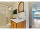 A small bathroom is seen through an open door adjacent to a laminate-floored bonus room at 4522 Long Cove Dr, Denver, NC 28037