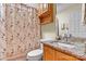 Bathroom with granite counters, a shower with a floral curtain, and a well-lit vanity mirror at 4522 Long Cove Dr, Denver, NC 28037