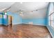 Large bonus room features laminate flooring, bright blue walls and windows for ample natural light at 4522 Long Cove Dr, Denver, NC 28037