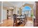 Elegant dining room featuring a chandelier, a large arched window and hardwood floors at 4522 Long Cove Dr, Denver, NC 28037